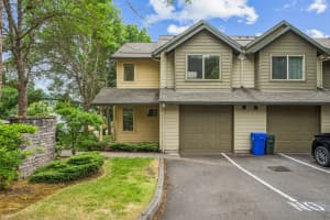 Roberts Court townhomes with attached garages and a landscaped entry