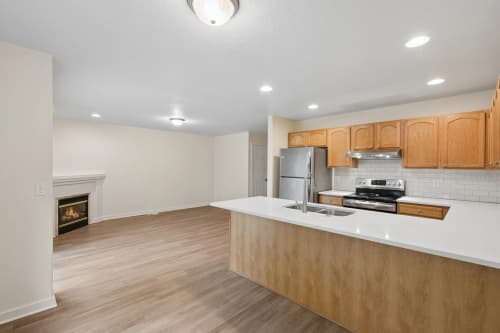 3-bedroom townhome kitchen peninsula with a view of the living room fireplace