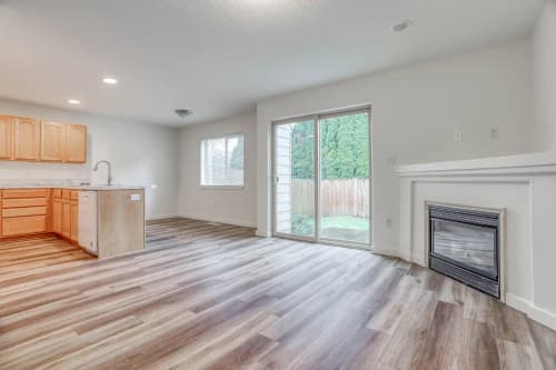 Bright living room with hardwood floors and large windows